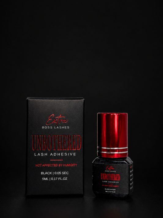 Lash adhesive bottle and packaging on a black background